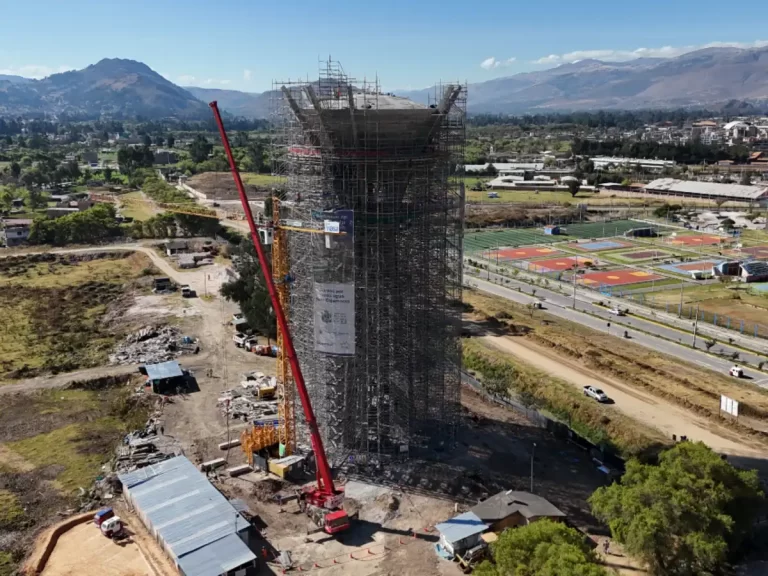 Grúa torre pesada realizando izaje en campamento minero a gran altura.